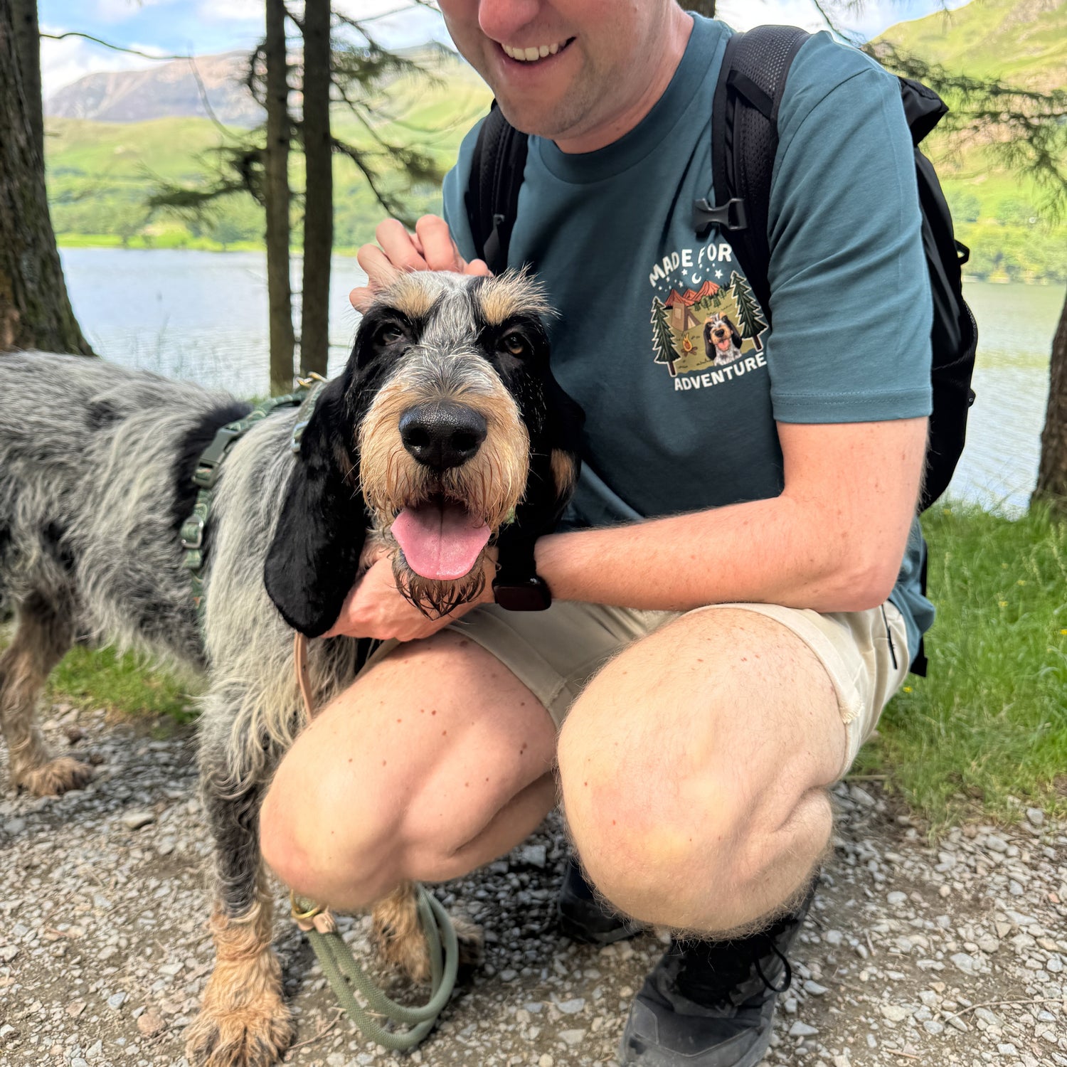 Man with a dog outdoors by a lake