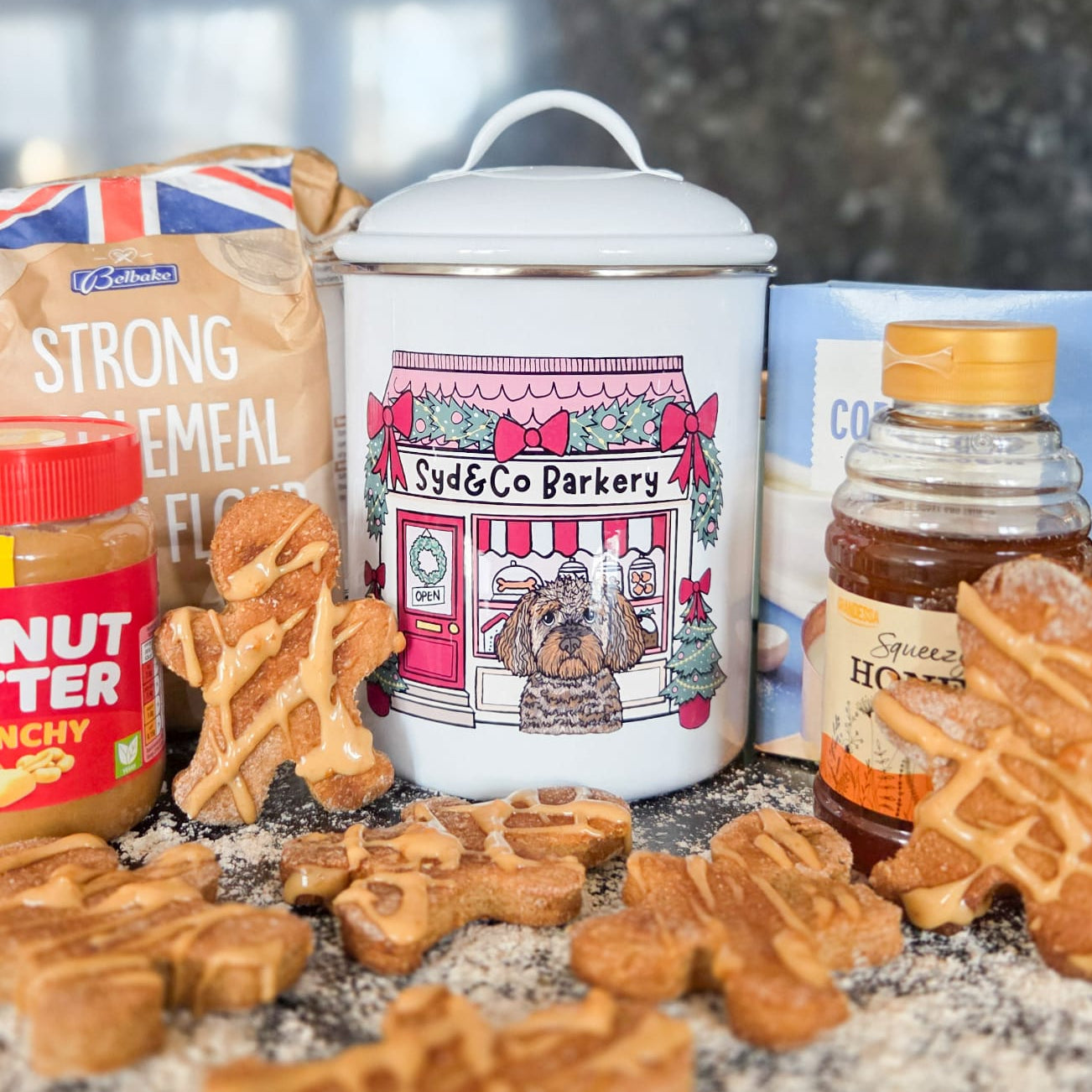 Dog treats and ingredients on a kitchen counter with a blurred background