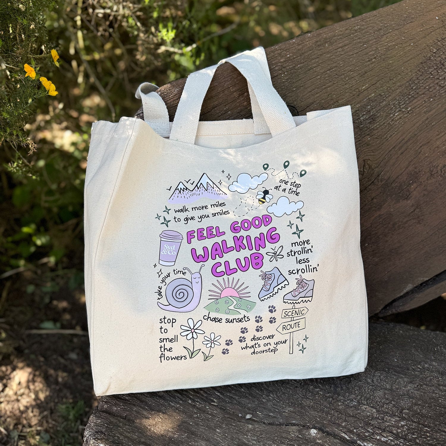 Tote bag with 'Feel Good Walking Club' design on a wooden surface with natural background