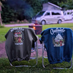 Two hoodies with outdoor-themed designs hanging on a stand outdoors.