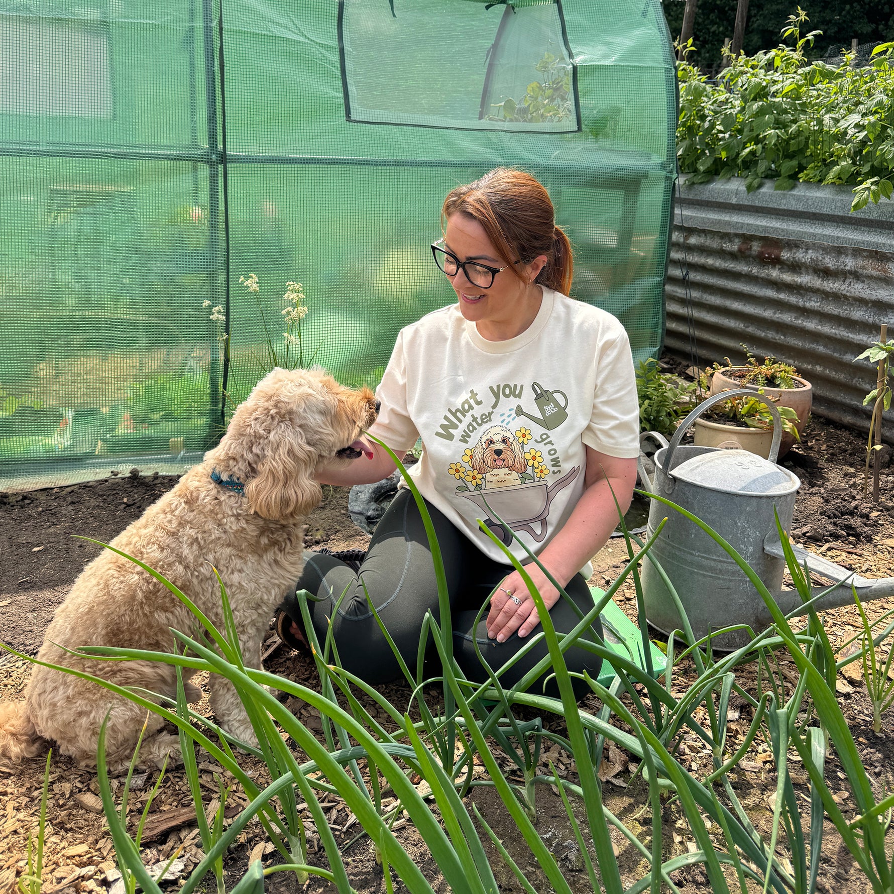 Woman sitting with a dog in a garden